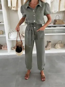 Detailed view of women casual washed denim utility jumpsuit with short sleeves and belt.