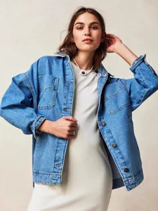 Classic oversized blue denim jacket for women, casual long sleeve outerwear with chest pockets.