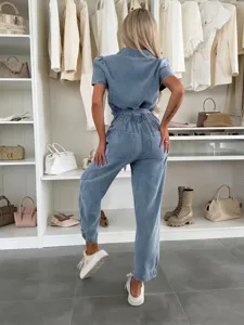 Casual light wash denim short sleeve jumpsuit featuring a cinched waist and relaxed fit.