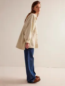 Casual loose long-sleeve women overshirt jacket in beige with side slits and dual pockets.