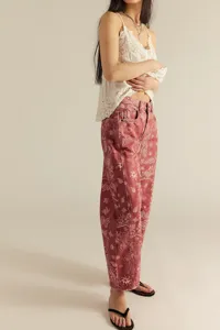 Detail view of casual loose mid-rise women straight jeans featuring elegant paisley print.