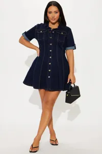 Close-up detail of the dark blue denim dress showing front button closure and rolled sleeves.