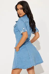 Denim dress detail showcasing lapel collar, roll-up short sleeves, and functional side pockets.