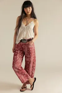Detailed view of casual loose mid-rise paisley print women denim jeans with lace camisole.