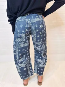 Back detail view of women casual loose mid rise straight denim jeans with white paisley print.