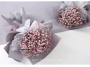 Detail view of Korean style floral wrapping paper bouquet with pink baby's breath and tulle.