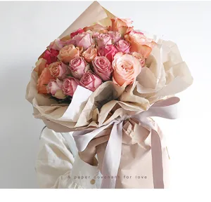 Exquisite bouquet detail shot showing delicate pink roses wrapped in layered Korean style paper.