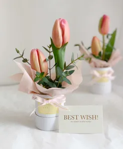 Mini flower gift box detail with pink tulips and greeting card for Mother Day celebration.