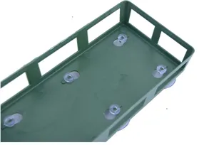 Detail view of green plastic floral foam holder with transparent suction cups for wedding car.