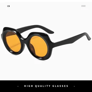 Retro oversized black round sunglasses with bold orange lenses for women fashion street style.