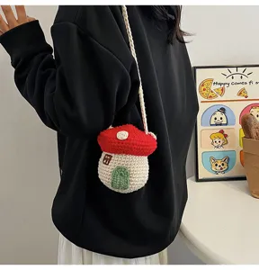 A cute handmade crochet mushroom bag shown being worn as a mini crossbody pouch
