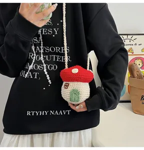 Close-up of a cute handmade crochet mushroom-shaped mini crossbody bag as a fashion accessory