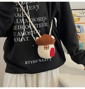 Close-up of cute crocheted mushroom cross-body bag worn by a model
