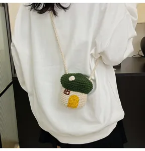 Cute crochet mushroom house mini crossbody bag worn by a model