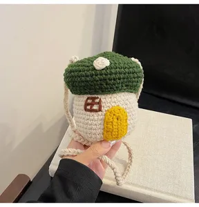 Close-up of handmade crochet mushroom-shaped mini crossbody bag with braided strap