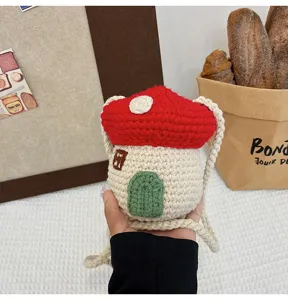 Close-up of cute handmade crochet mushroom shaped mini crossbody bag