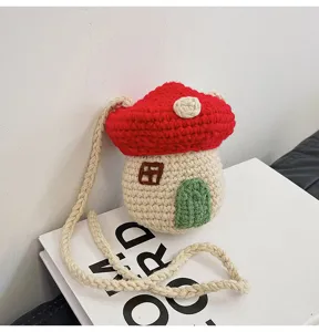 Close-up view of a cute handmade crocheted mushroom house crossbody bag for women and girls.