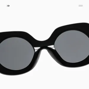Detailed view of women oversized round sunglasses, black chunky frame chic retro eyewear.