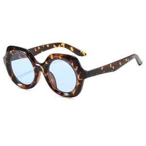 Detailed view of women's vintage oversized round tortoiseshell sunglasses with light blue lenses.