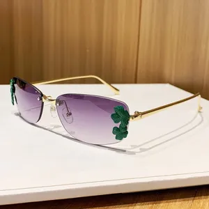 Metal rimless sunglasses with gradient purple lenses and chic green leaf decorations for women.