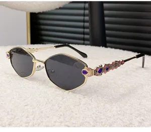Luxury metal hexagonal sunglasses for women with stylish rhinestone decorated temples.