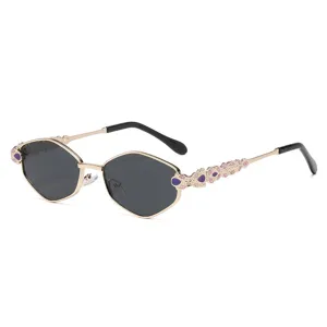 Luxury polygonal sunglasses for women with elegant jeweled temples and metallic gold frame.