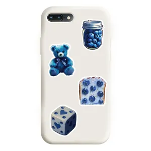 White phone case featuring aesthetic blue stickers including a cute bear and blueberries.