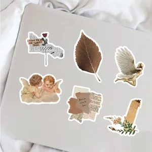 Close up of vintage aesthetic decorative stickers detail on laptop surface, retro art style.