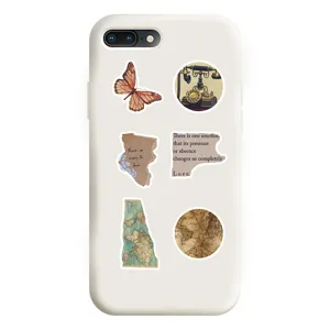 Detailed close-up of a white phone case decorated with vintage aesthetic stickers.