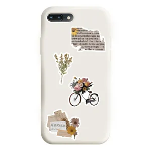 White phone case with vintage style botanical and newspaper collage stickers, detail view.