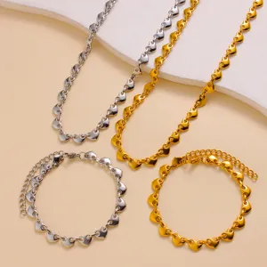 Stainless steel heart link chain necklace bracelet set detail display showing silver and gold tones.