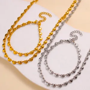 Stainless steel heart link chain necklace and bracelet set in gold and silver finish.
