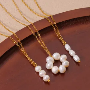 Elegant freshwater pearl necklace set with gold chain, versatile floral and drop pendant design.