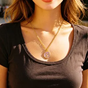 Gold plated stainless steel Scorpio zodiac necklace with purple enamel pendant detail.