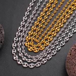 Stainless steel coffee bean chain jewelry detail closeup, multi-strand gold and silver necklaces.