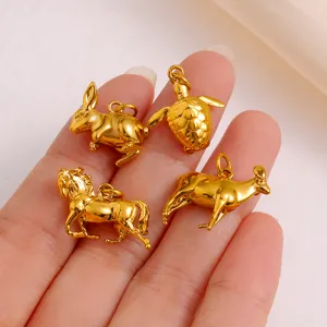 Detail shot of four glossy gold zodiac animal pendants, perfect for DIY jewelry making.