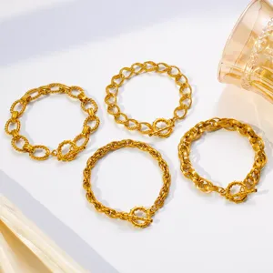 Close-up detail of luxury gold-plated twist chain bracelets with OT toggle clasps.