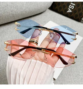 Trendy rimless polygonal sunglasses with colorful cut lenses and chic metal claw accents.