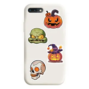 Detailed view of white phone case showcasing festive Halloween pumpkin and skull sticker designs.