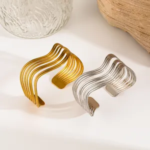 Detail showing gold and silver multi-layer stainless steel open cuff bangles