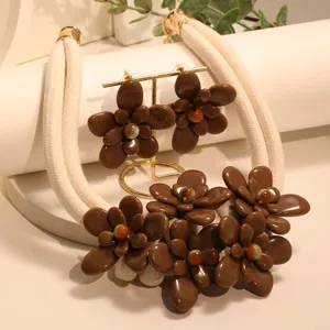 Close-up of brown acrylic flower jewelry set with beige rope necklace and earrings