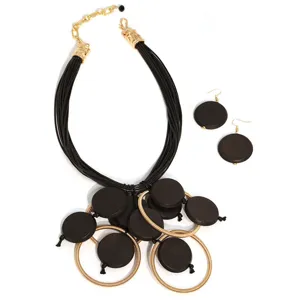 Primo piano di un set di gioielli bohémien con collana multistrato e orecchini in legno tondi.