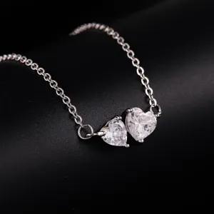 Close-up detail view of the double heart crystal pendant necklace showcasing sparkling zircon stones.
