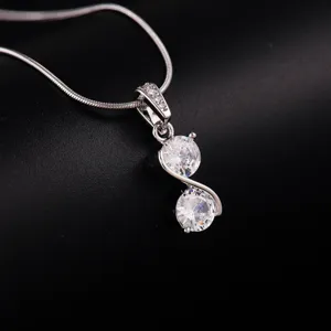Detailed view of a silver double-stone pendant necklace showcasing polished sparkle.
