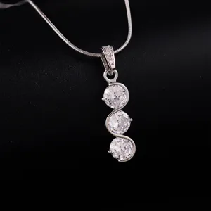 Close-up detail of the triple cubic zirconia pendant necklace showing fine sparkle.