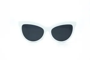 Close-up detail of vintage white cat-eye sunglasses with dark lenses for women fashion.