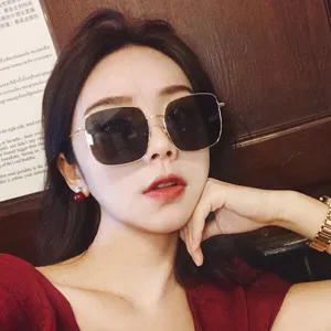 Square metal sunglasses detail view, stylish oversized frame and polarized lenses for daily wear.