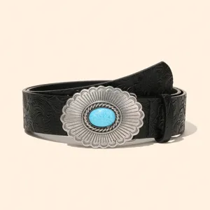 Detailed view of western style embossed leather belt with ornate silver turquoise buckle.