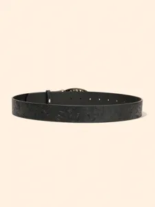 Detailed view of retro embossed floral leather belt, elegant women's waist accessory.