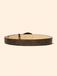 Vintage embossed leather belt detail showing intricate western floral tooling and texture close up.